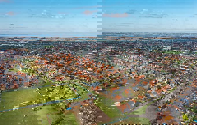 A birds eye view of a thriving town filled with red brick homes